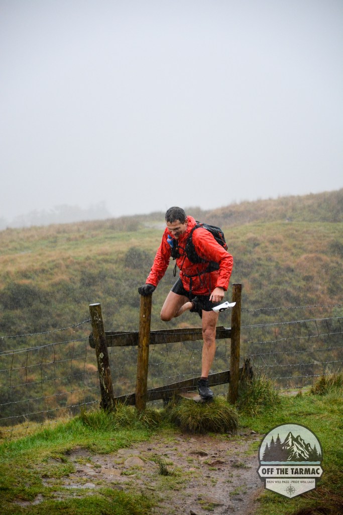 A runner climbing over a style in the Brecon BeaconsA photo during the OTT Ultra Marathon. Give us a call if you need running event photography at your event